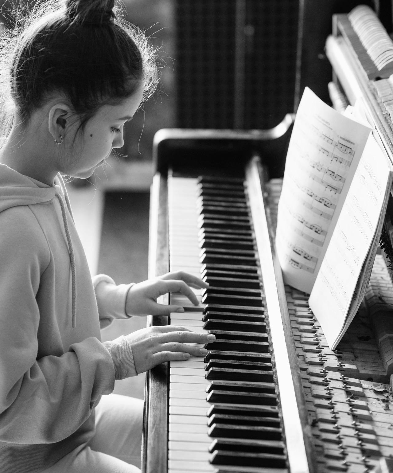 Person having a piano lesson